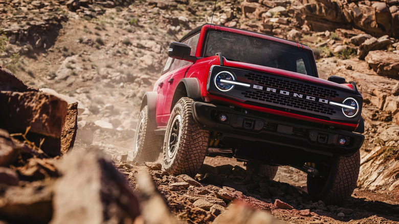 Front view of red Ford Bronco Badlands on rocky desert trail.