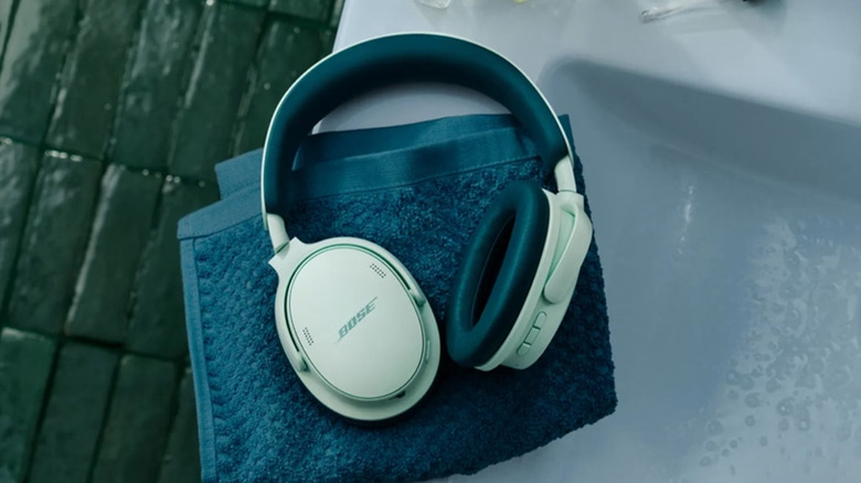 A pair of Bose QuietComfort 2nd generation headphones on a table.