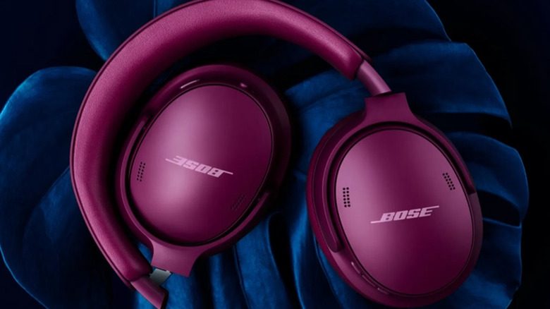 A pair of Rosewood Mauve QuietComfort headphones on a blue cloth.