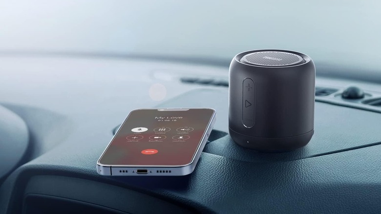 Anker speakers on dashboard next to a phone