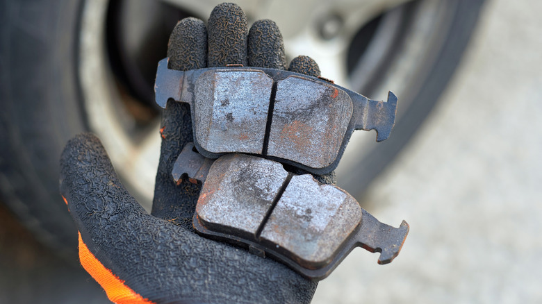 A mechanic holding brake pads