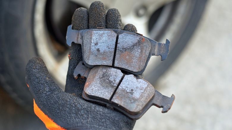 A mechanic holding brake pads