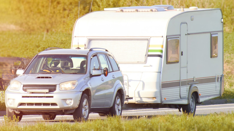 A car pulling a trailer along a route