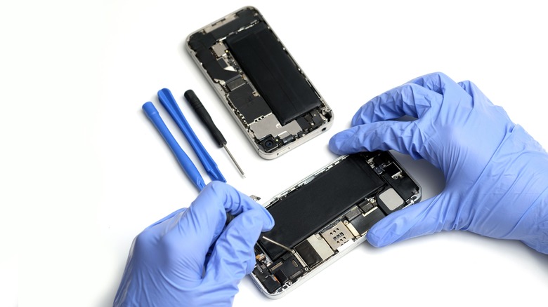 gloved hands servicing smartphone