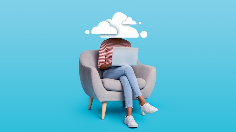 laptop user with cloud over head