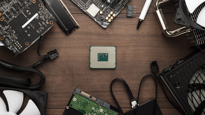 A CPU on a wooden desk with other components around it