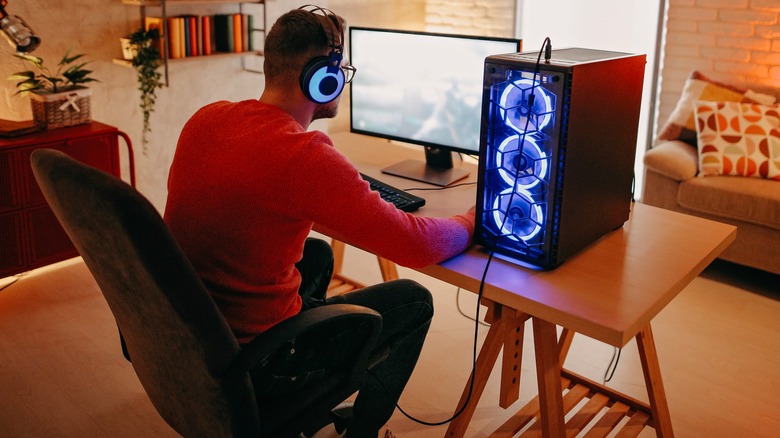 man sitting at gaming PC