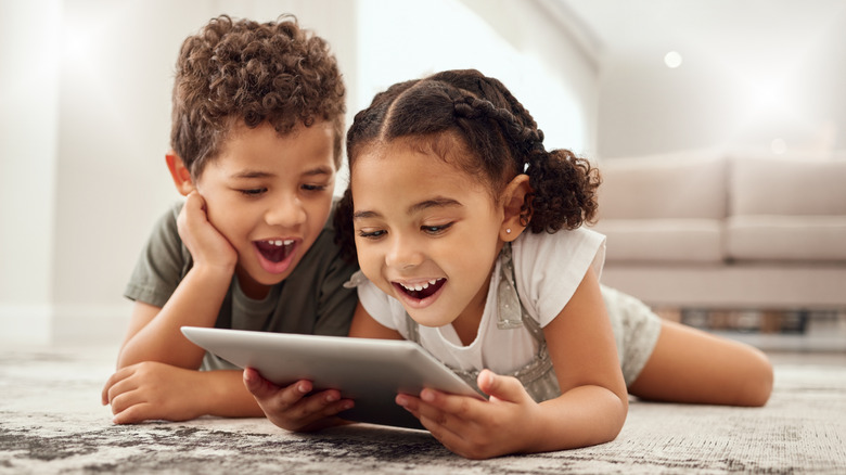 Two children watching content on a tablet