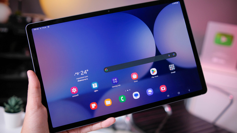 A person holding the Samsung Galaxy Tab S10+ tablet