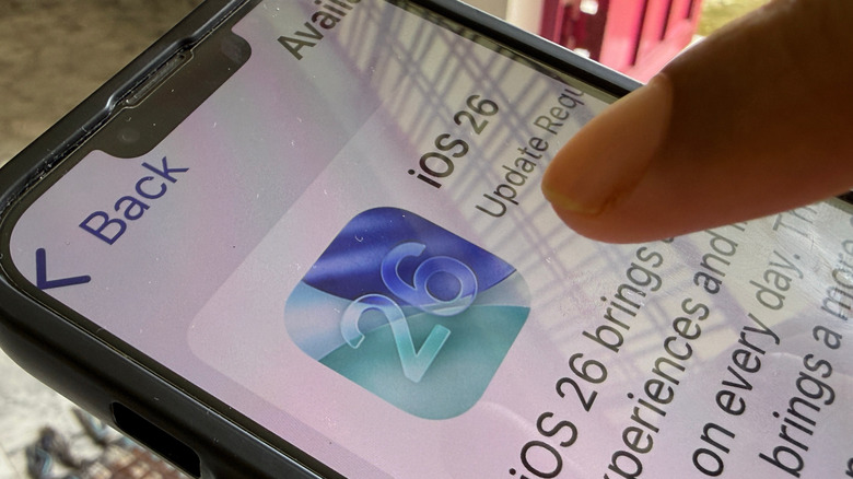 A person updating their iPhone to iOS 26