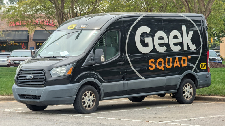 Geek Squad van for the electronics retailer Best Buy resting in a parking lot.
