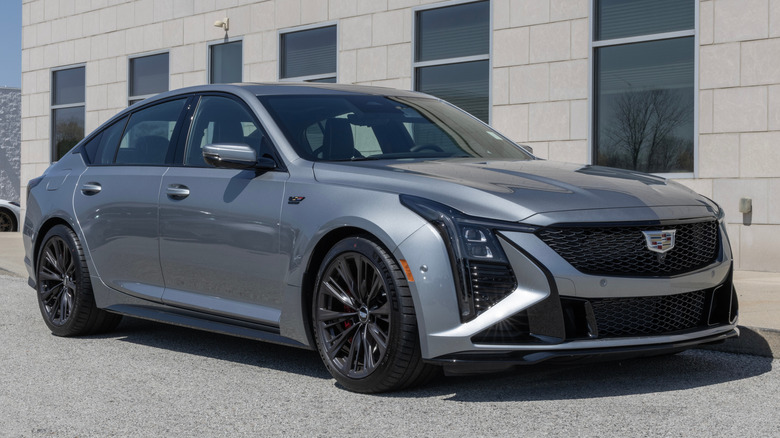 Front 3/4 view of silver Cadillac CT5-V Blackwing parked in front of building.