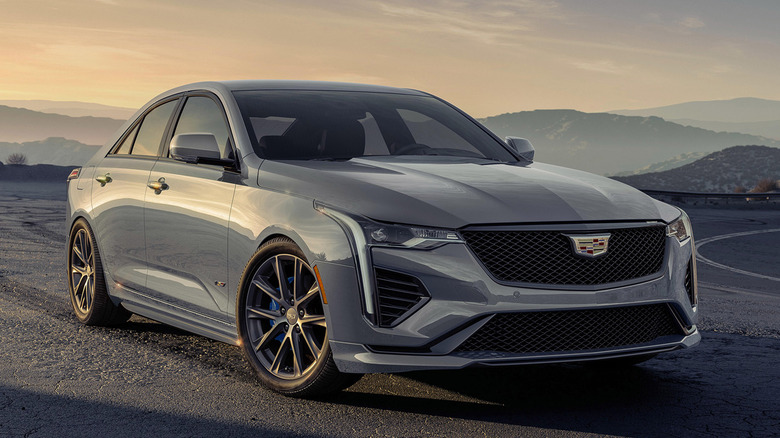 Front 3/4 view of gray Cadillac CT4-V on road in mountainous setting