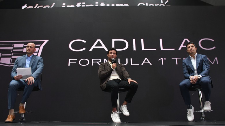 Checo Pérez speaking at press conference with Cadillac Formula 1 team managers