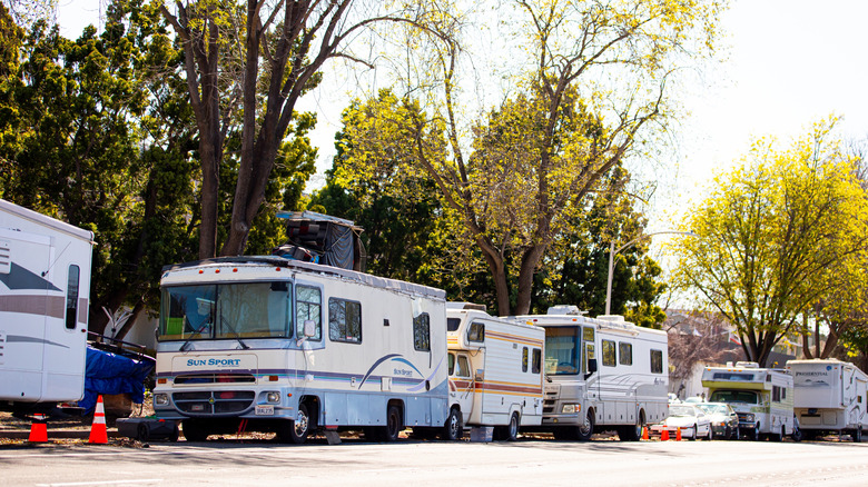 RVs lining a street in California amid traffic cones