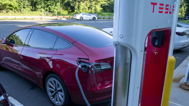 Tesla plugged in charging station