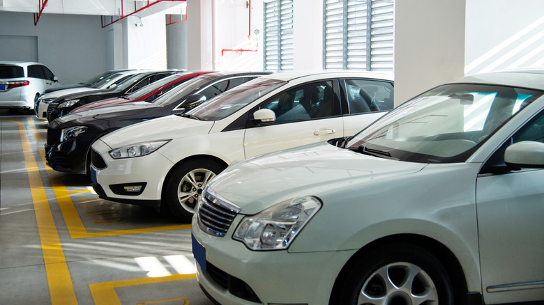 Cars parked in a packed garage