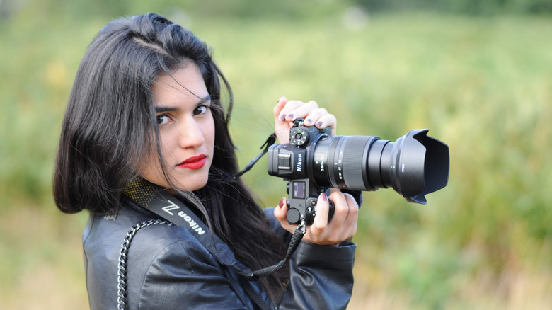 Woman showing off Nikon camera
