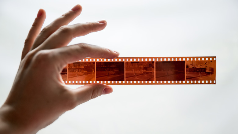 Hand holding a strip of film