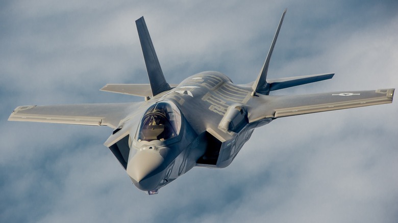 A U.S. Air Force F-35A Lightning II flying over cloudy skies