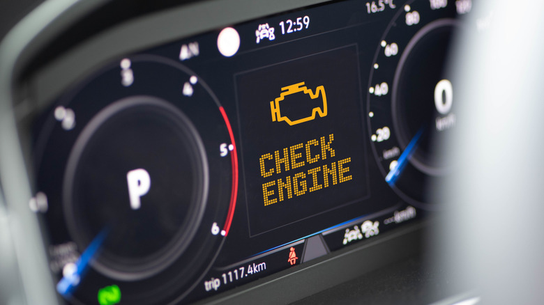 Instrument cluster of a modern car with a check engine warning light on