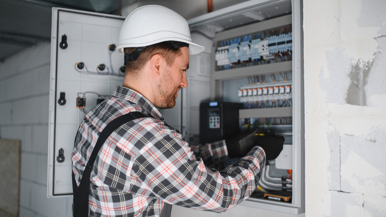 Electrical expert testing circuit breakers in an under construction building