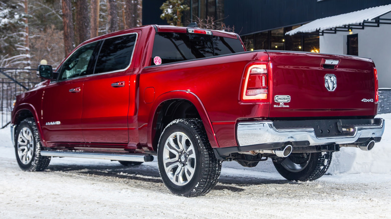 Rear 3/4 view of a red RAM 1500 diesel parked outside in the winter