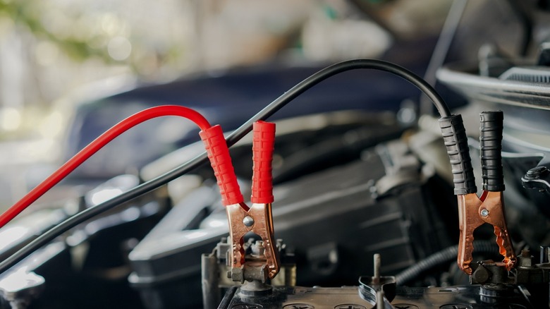 a pair of jumper cables connected to a car battery