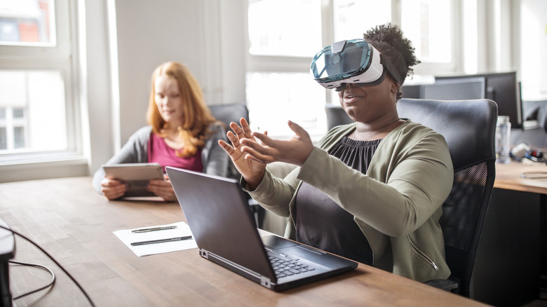 woman using vr with laptop