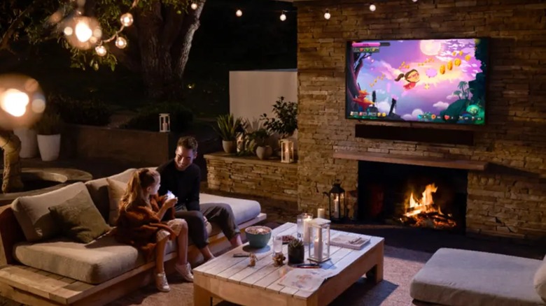 dad and child outdoors with tv