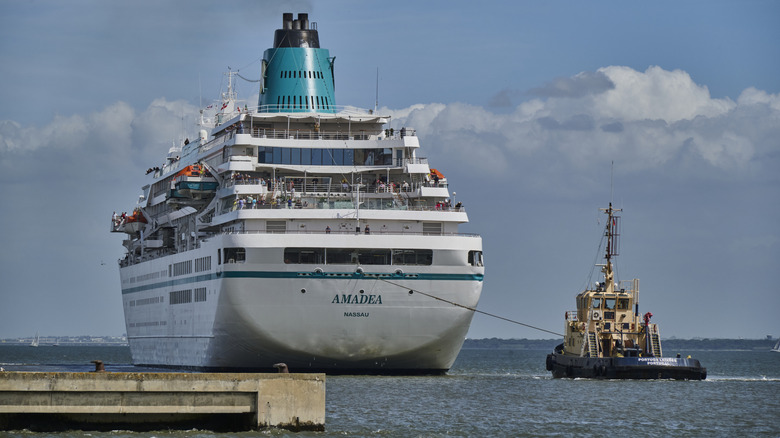 A tugboat helps MS Amadea, a 28,856 GT cruise ship