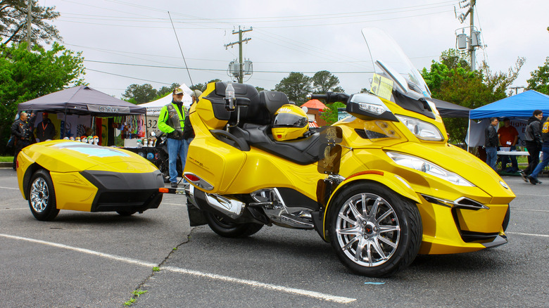 A yellow Can-Am Spyder RT with a matching trailer