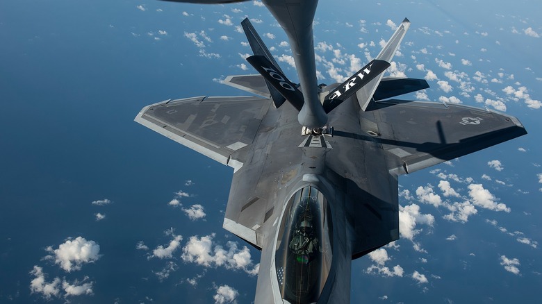 An F-22 Raptor being refueled over the ocean