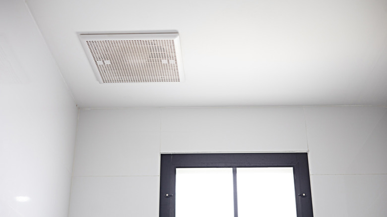 A ceiling exhaust fan near a window on a sunny day