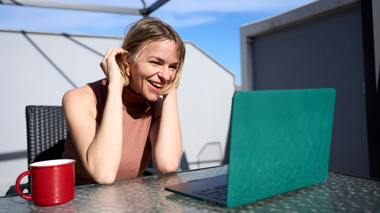 Woman using a laptop in the sun