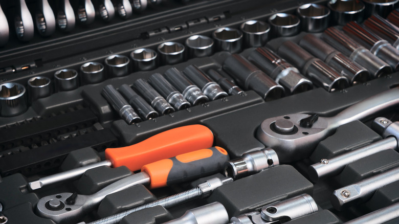 A toolbox with many different tools, including pliers, wrenches, and screwdrivers