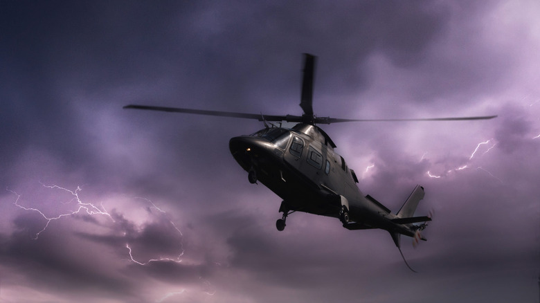 A helicopter flying against a stormy sky.