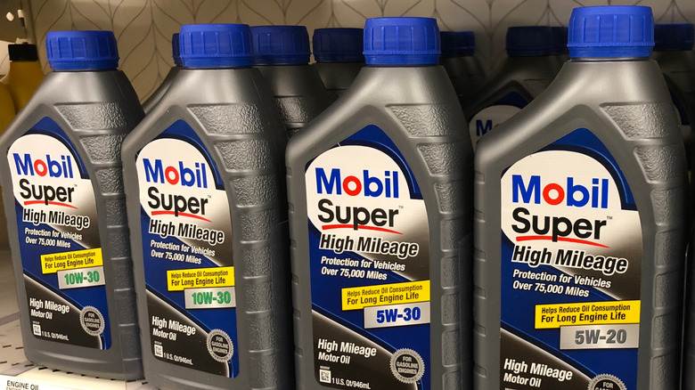 Bottles of Mobil Super High Mileage oil on store shelf