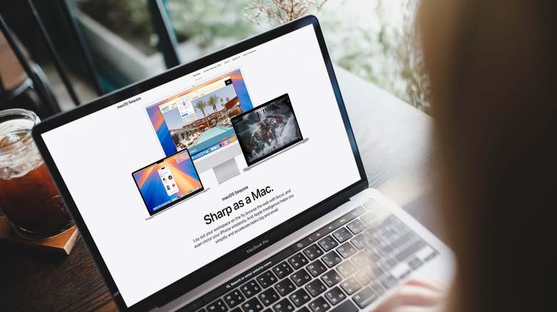 MacBook Pro open in Apple website with coffee in the background
