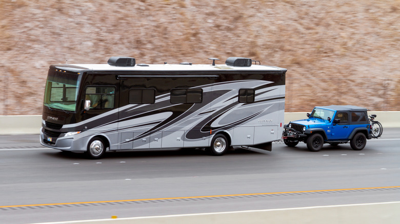 A Motorhome Flat Towing A Jeep Wrangler