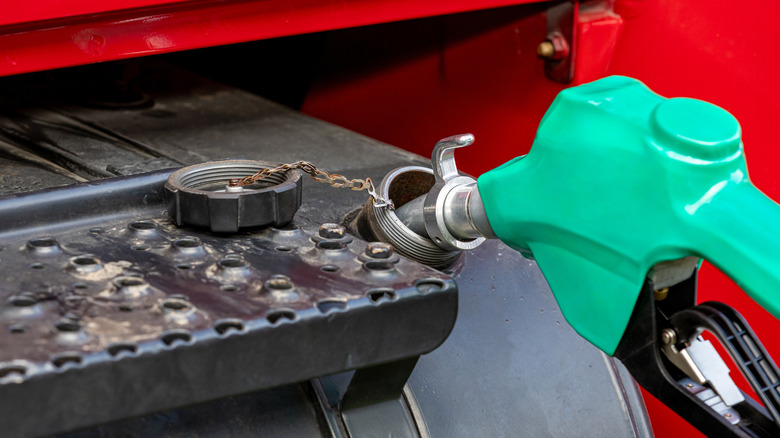 Diesel fuel nozzle fueling semi tractor, grain truck.