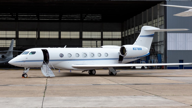 A private jet outside a hangar.