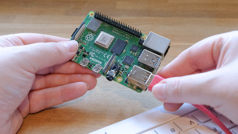 hands working with Raspberry Pi