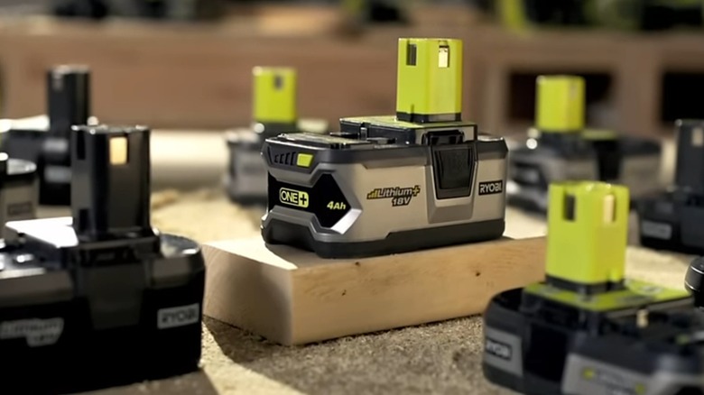 Several Ryobi batteries on a table.