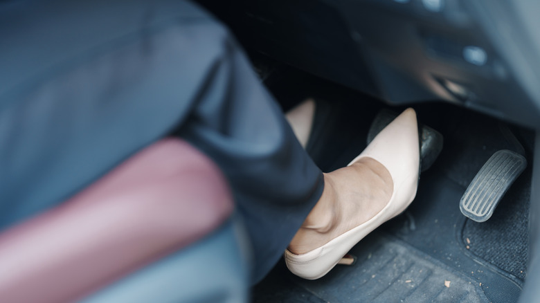 Woman's foot hitting car brakes