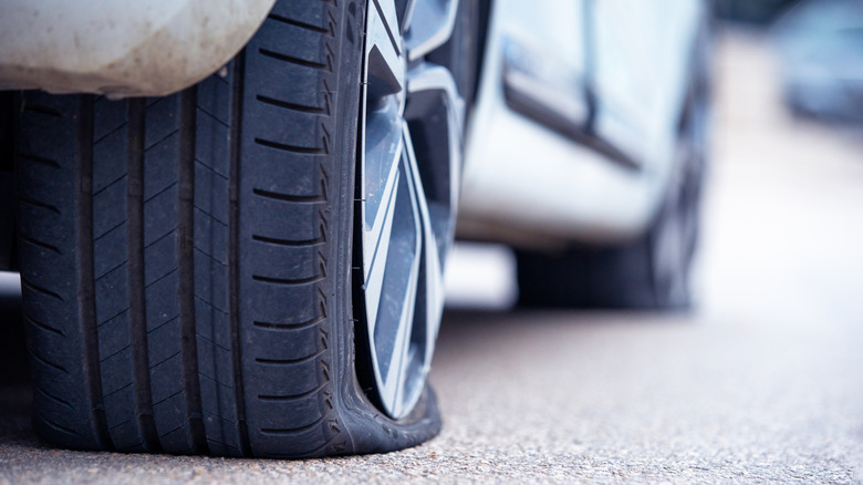 Flat car tire on pavement
