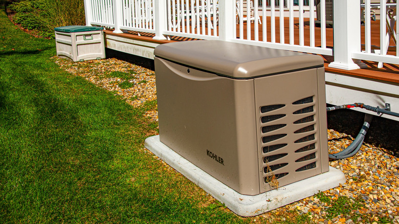 Home generator installed outside porch