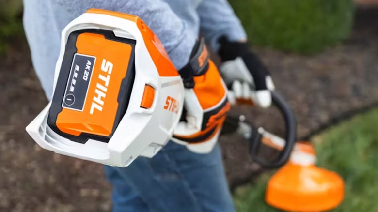 A Stihl AK 20 battery pack in a string cutter