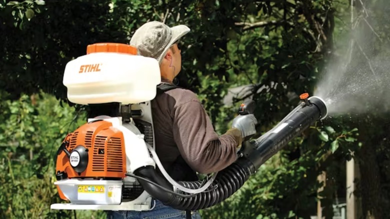 man using Stihl SR 450