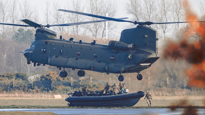 A CH-47 Chinook helicopter hovering above boat